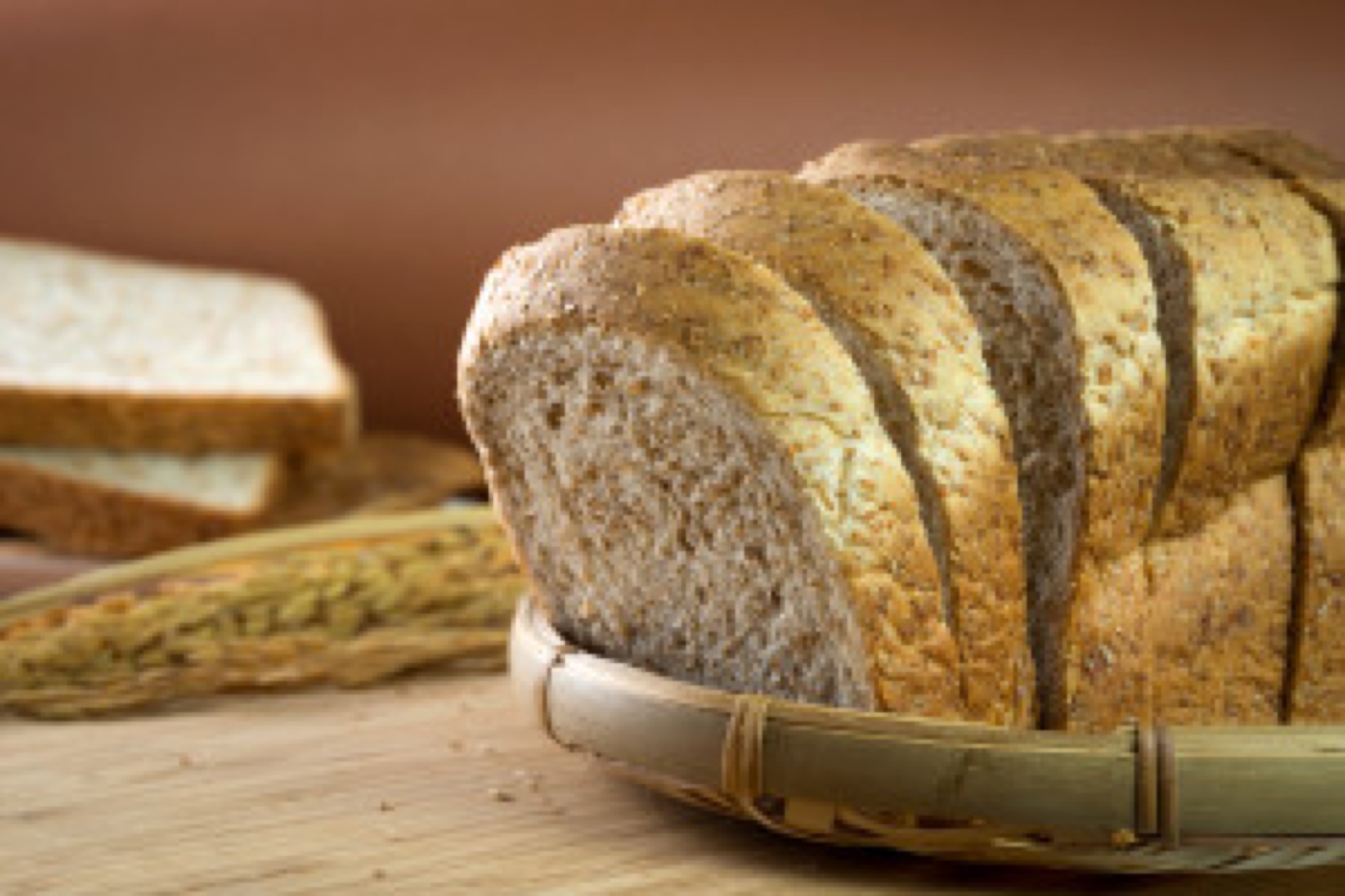 Sliced whole wheat bread loaf on bamboo basket