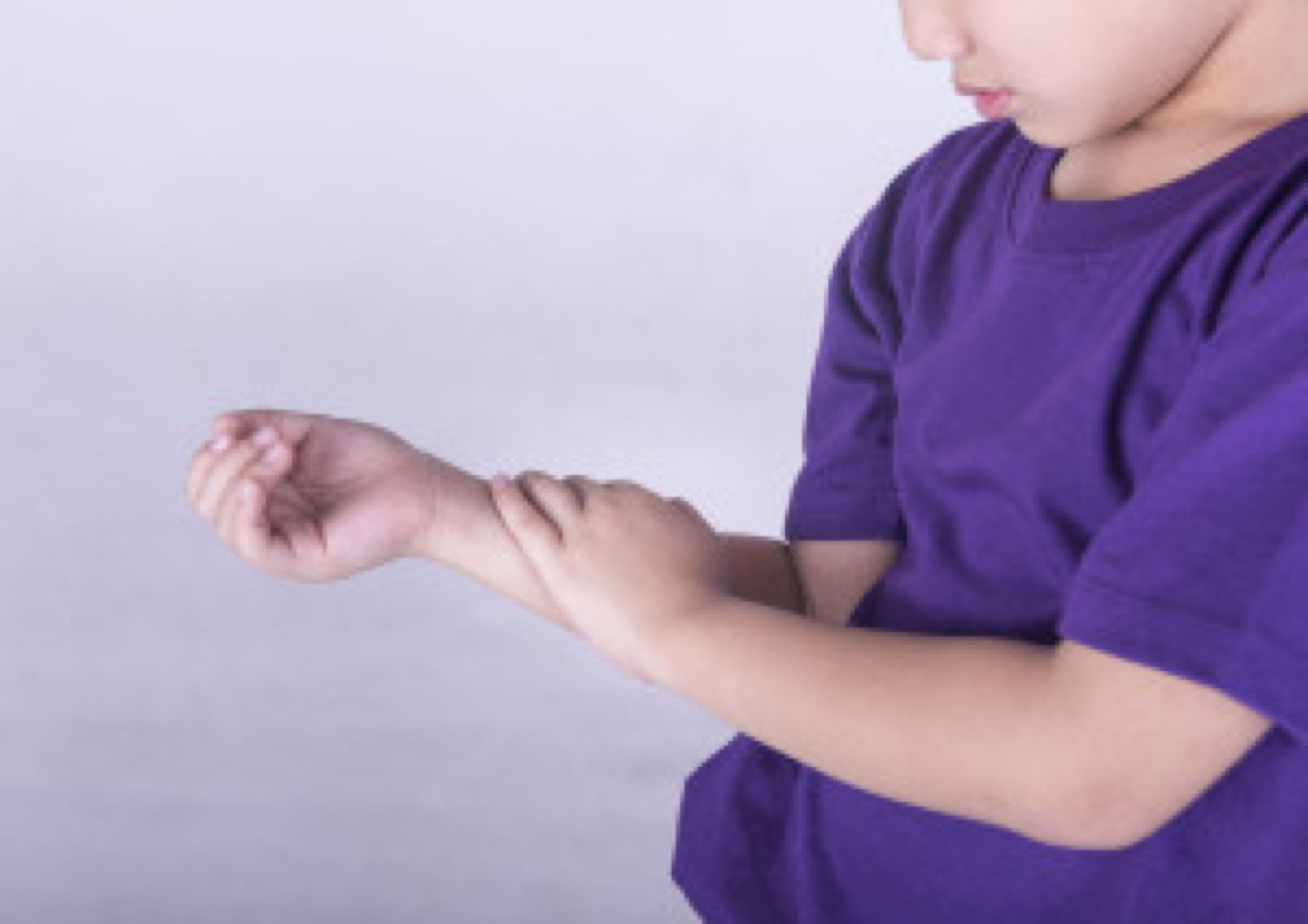 Boys checking his arm with muscle pain.