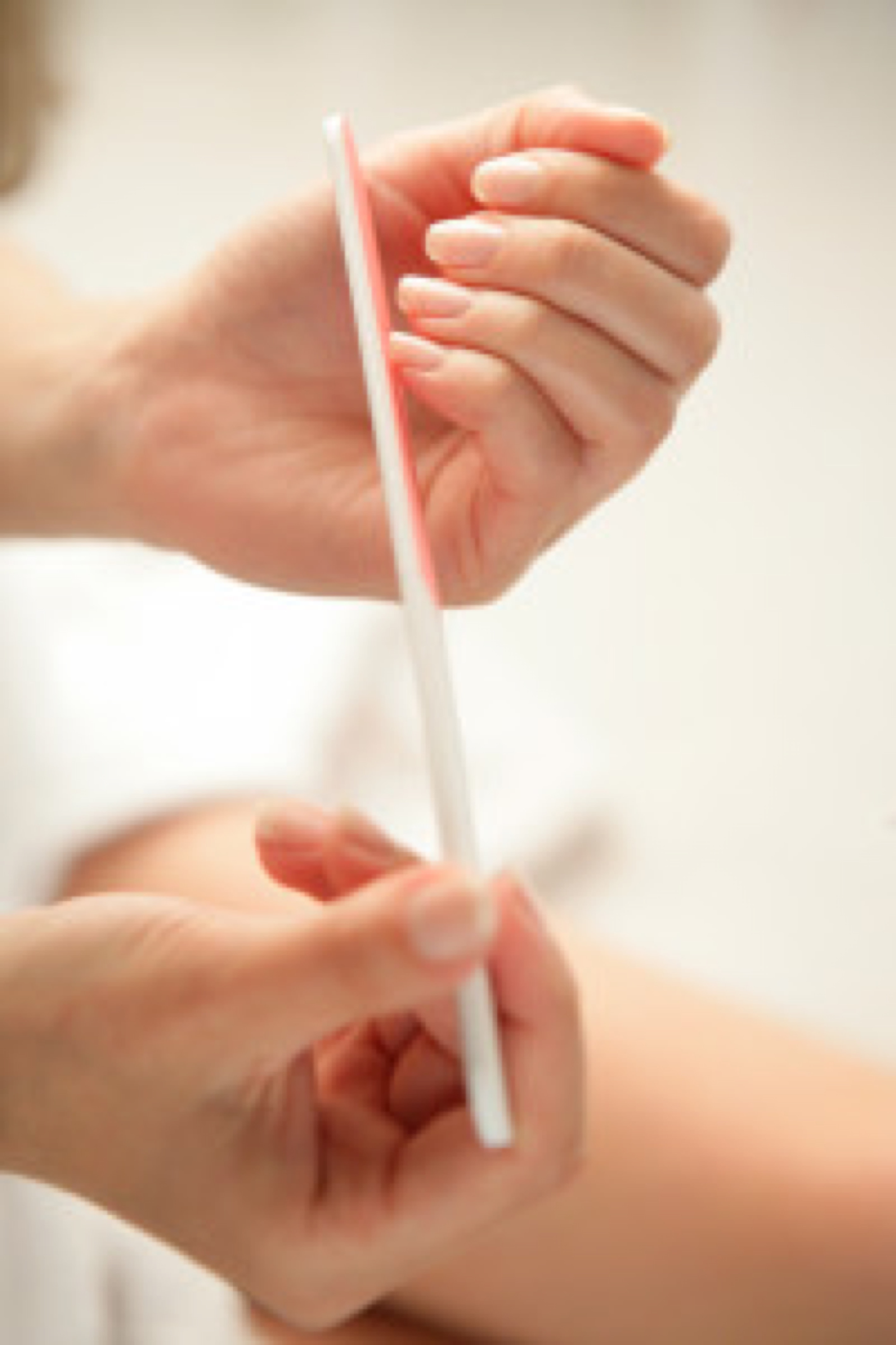 Young woman filing her nails