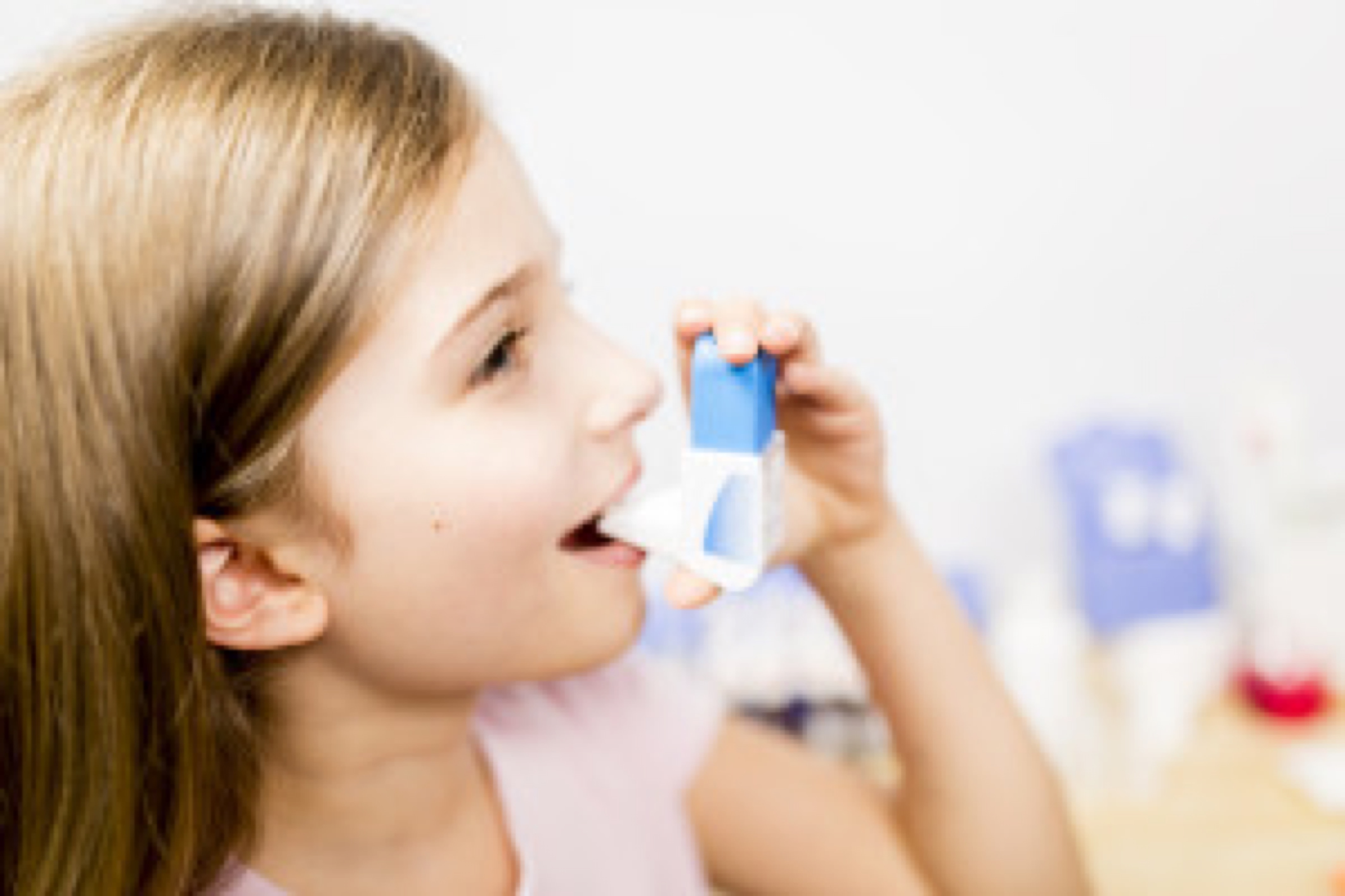 Allergy - cute girl using inhaler