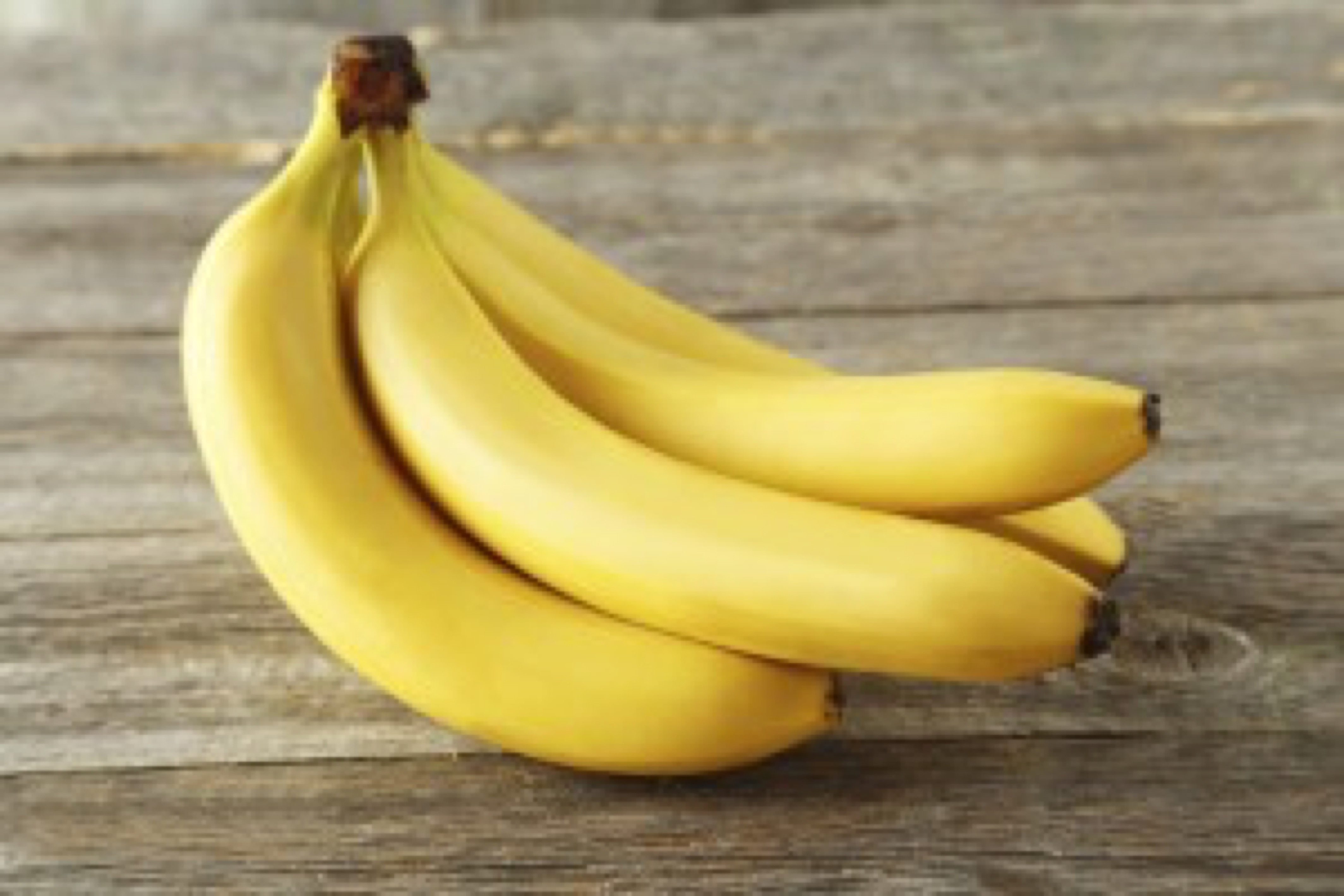 Bunch of bananas on grey wooden background