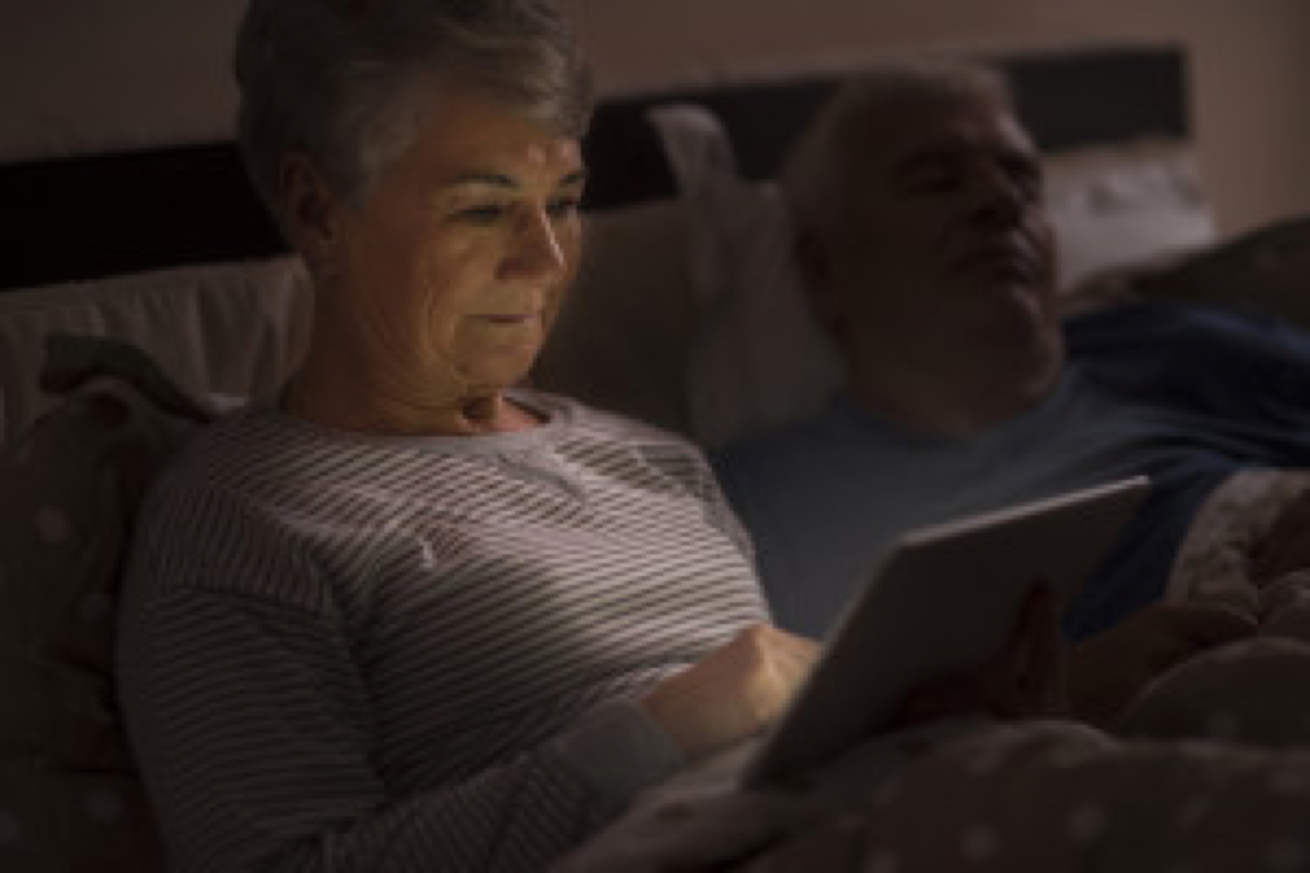 Grandmother browsing the Internet late at the night
